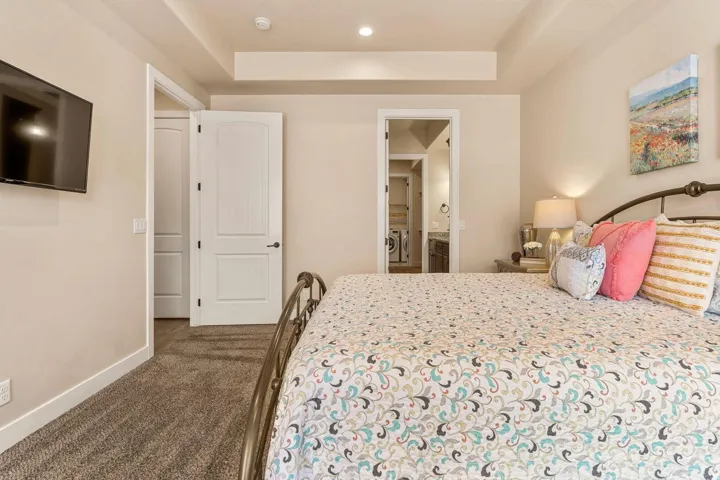 Recessed lighting, tray ceiling, and neutral wall tones