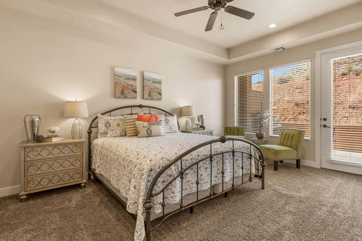 Room featuring a tray ceiling, recessed lighting, and a ceiling fan