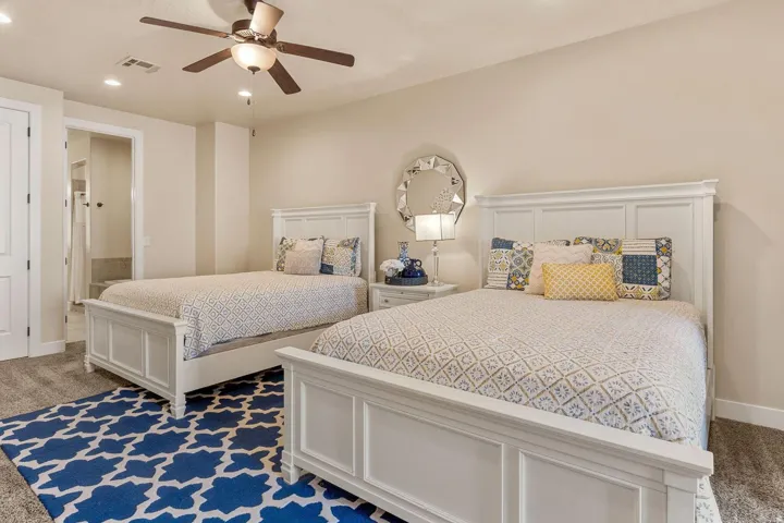 Spacious room featuring neutral wall tones, recessed lighting, and a ceiling fan with integrated lighting