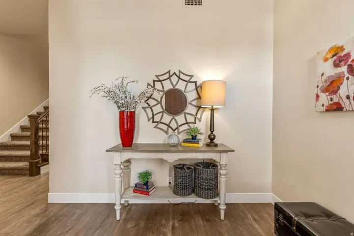 Entryway featuring wood-finish flooring, light neutral wall paint, and white baseboards