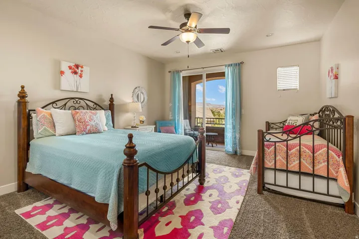 Carpeted bedroom featuring a ceiling fan with integrated lighting, recessed lighting, and a sliding glass door opening to an outdoor balcony