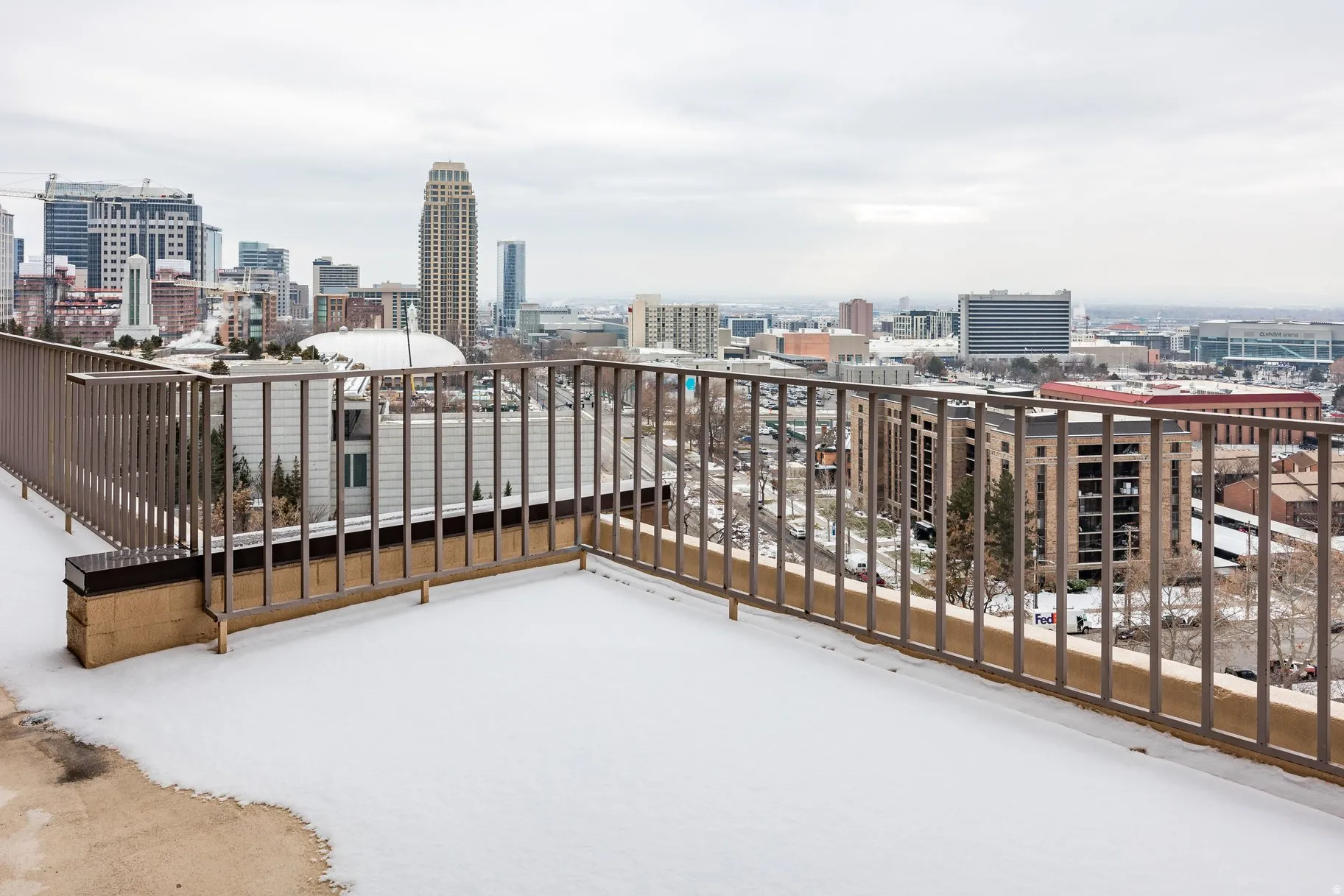 Rooftop terrace with metal railings providing sweeping urban panoramas