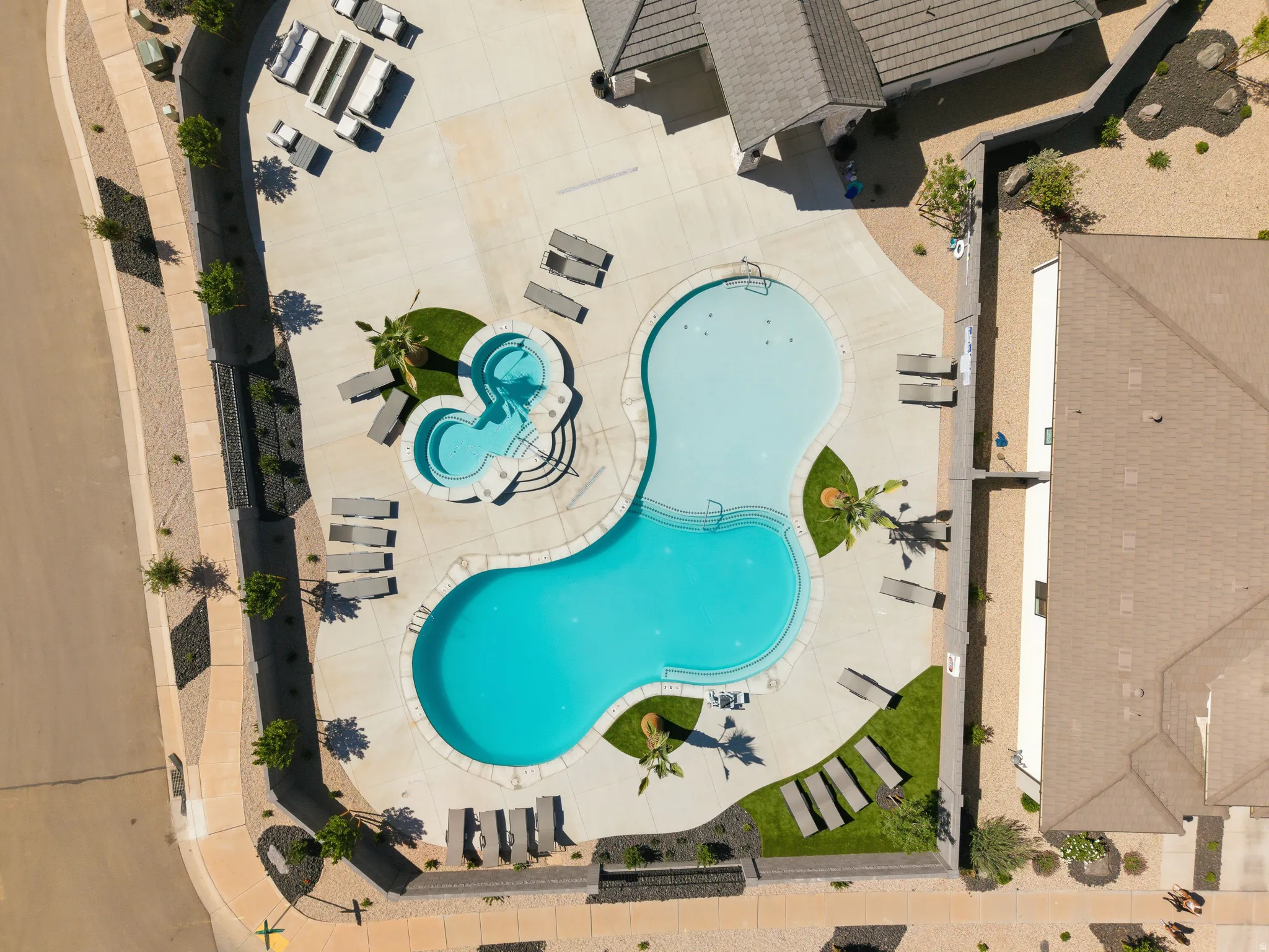 Recreational area featuring a large freeform swimming pool and a separate spa with integrated steps