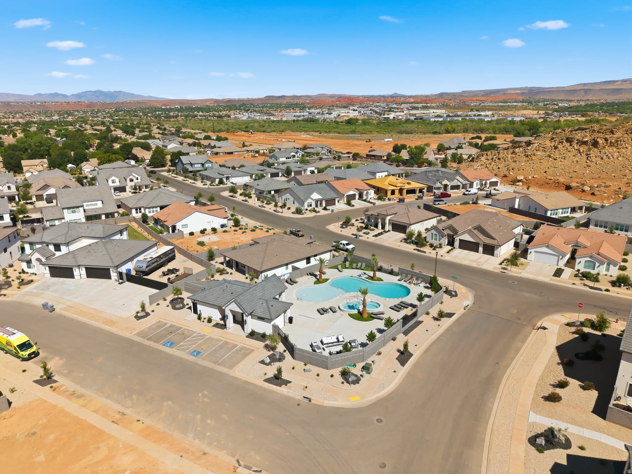 Community amenities featuring a central swimming pool with integrated spa, surrounding lounge areas, and desert landscaping