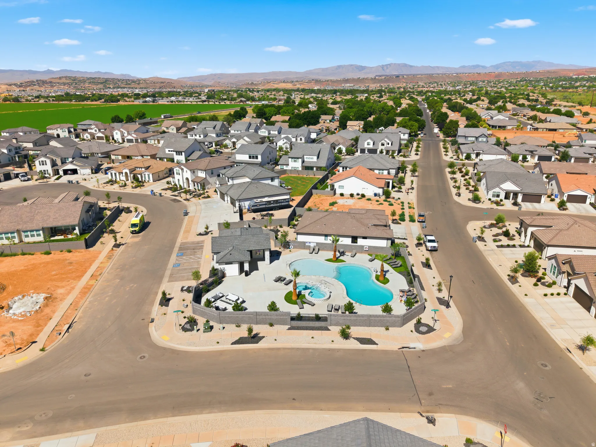 Aerial perspective showcasing a residential community with varied rooflines and a central amenity area
