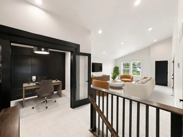 Private office space with paneled wall detail and French doors, vaulted ceiling, recessed lighting, and large windows