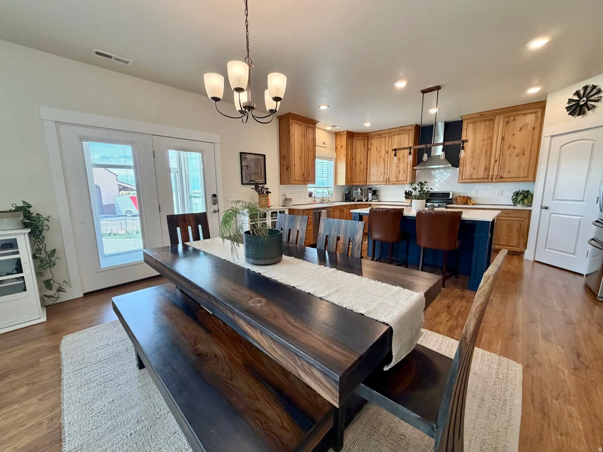 Open-concept dining and kitchen area featuring wood-finish flooring