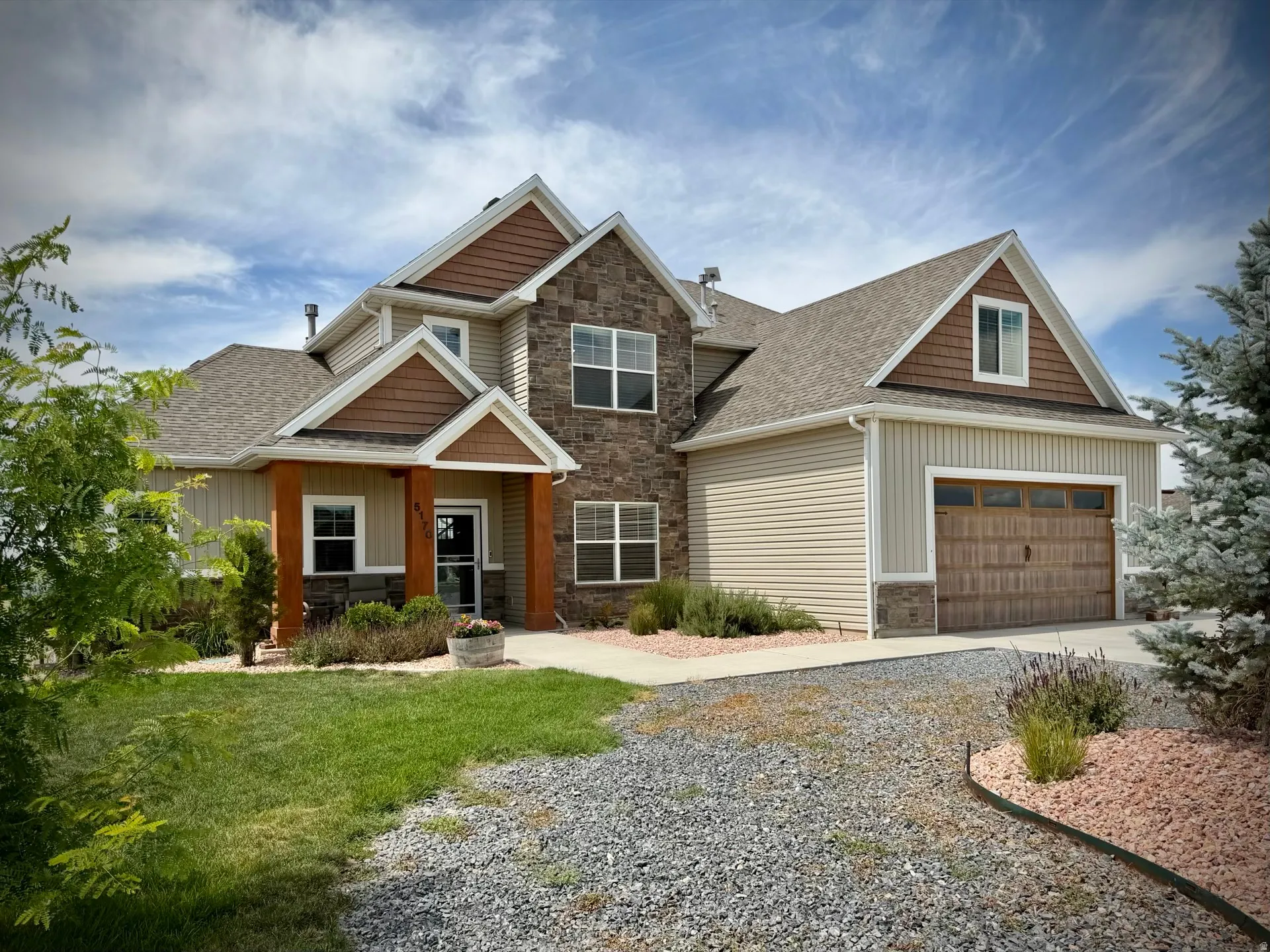 Multi-textured exterior featuring stone accents, horizontal siding, and vertical board-and-batten siding
