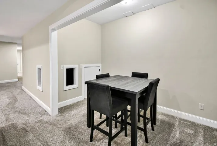 Open room featuring wall-to-wall carpeting and neutral wall paint