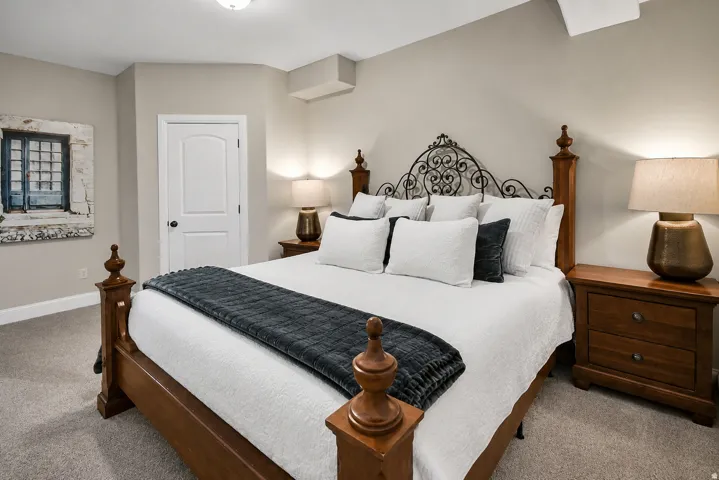 Carpeted bedroom with neutral wall tones and a white interior door