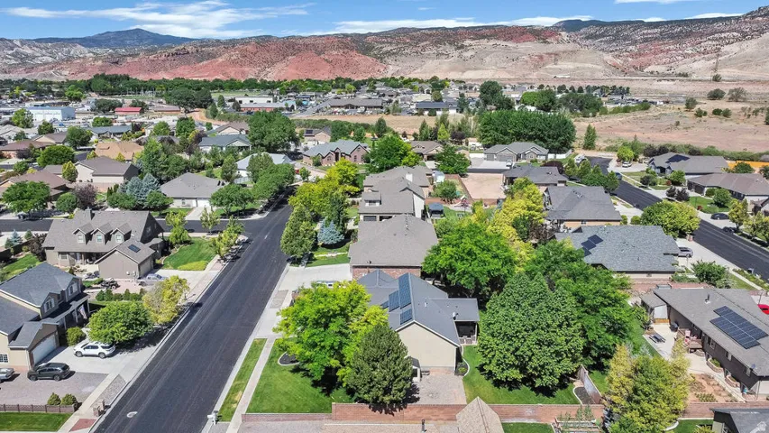 Residential neighborhood featuring mature trees and mountain scenery