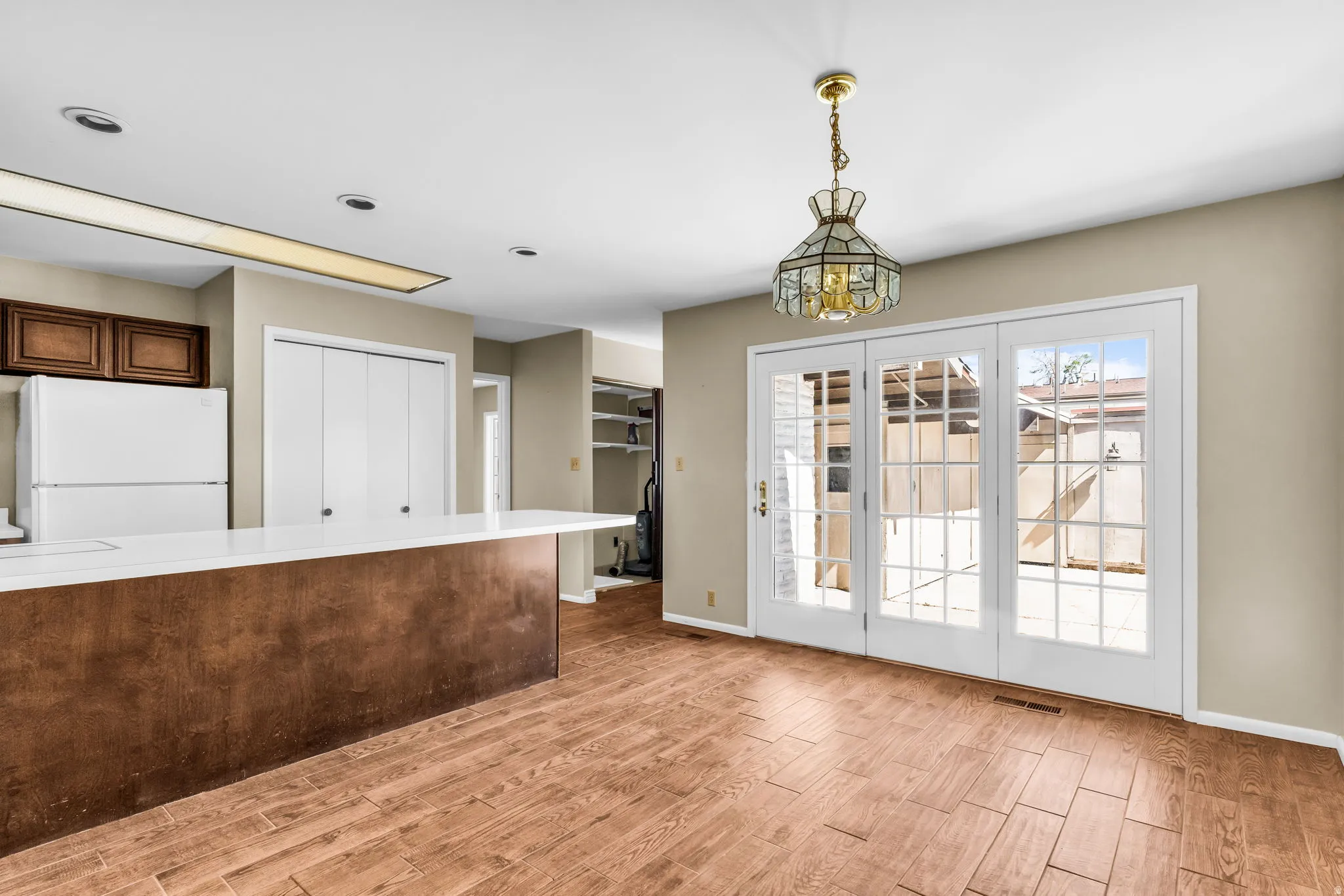 Open concept living area featuring wood-finish flooring and neutral wall tones