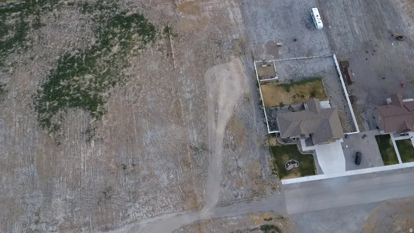 Spacious undeveloped land parcel with existing residential properties on paved streets