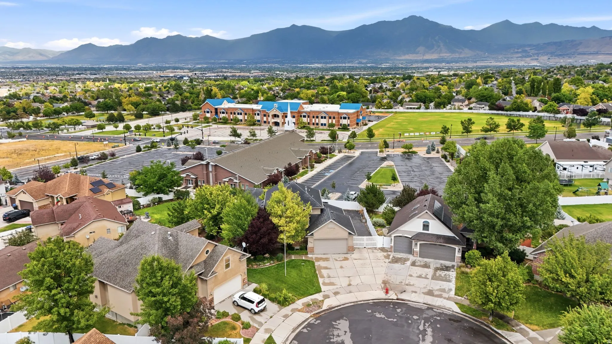 Aerial perspective showcasing a residential area with varied rooflines and established landscaping