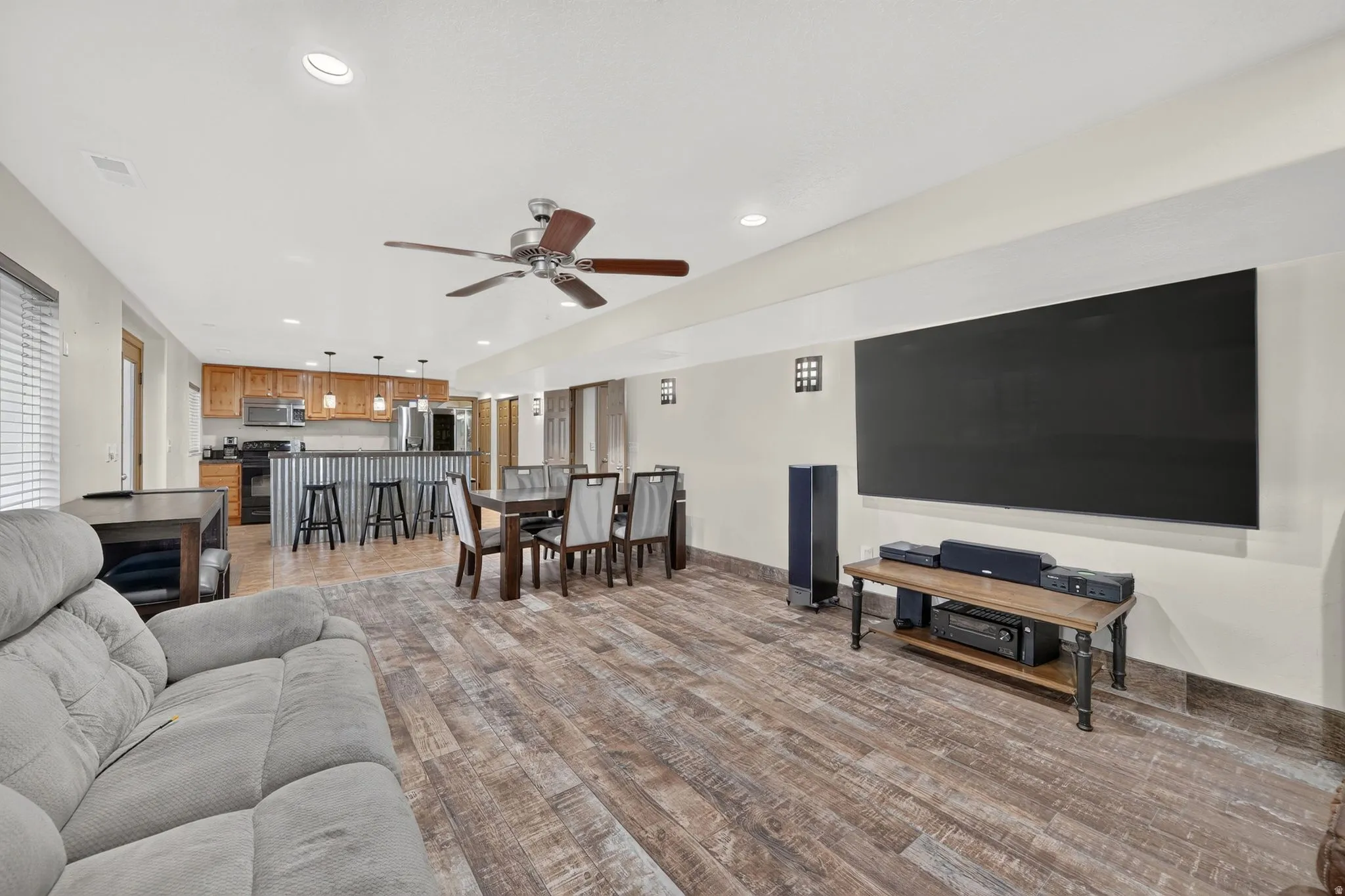 Open concept living space featuring wood-finish flooring