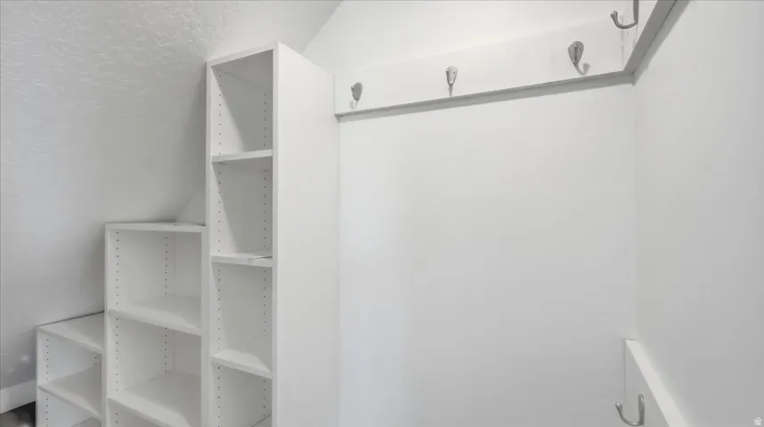 Built-in shelving and wall-mounted hooks provide organized storage solutions
