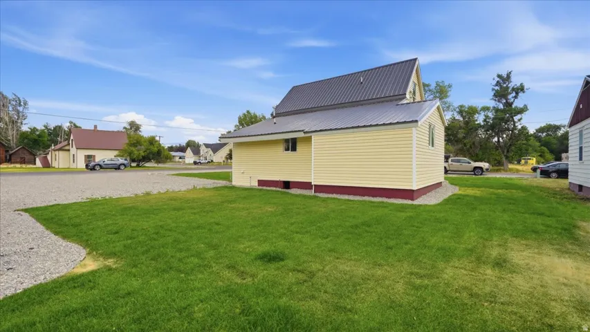 Light yellow siding with dark red foundation trim