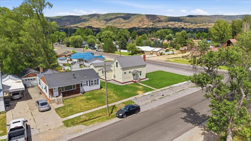 Aerial perspective showcasing a residential street with mountain backdrop