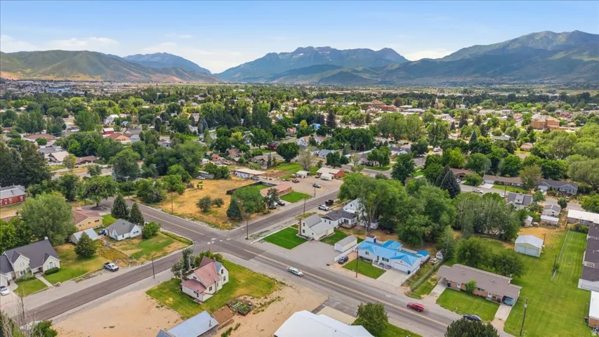 Expansive aerial perspective showcasing a residential neighborhood with distant mountain ranges