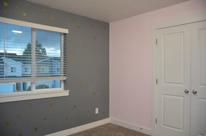 Interior room with a double-pane window featuring white blinds, framed by white trim