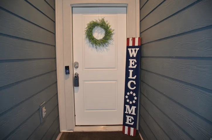 Entry door with smart lock system, video doorbell, and plank-style siding