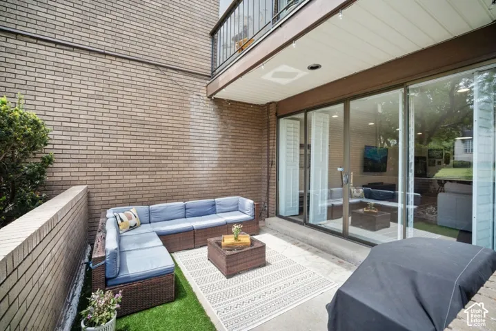 Private patio featuring a concrete surface and artificial turf