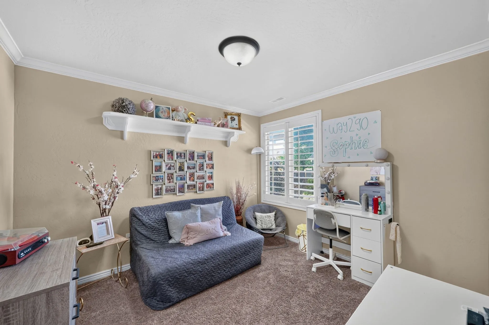 Third spare bedroom featuring neutral-toned room with crown molding and textured walls
