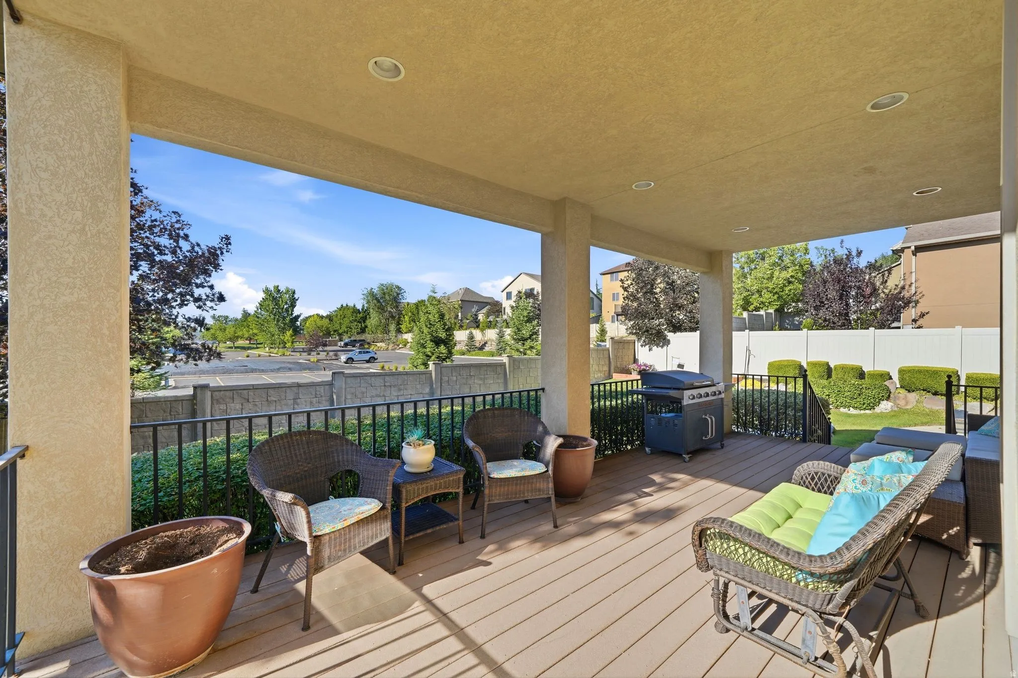 Covered patio featuring a composite deck, recessed lighting, and sturdy support columns