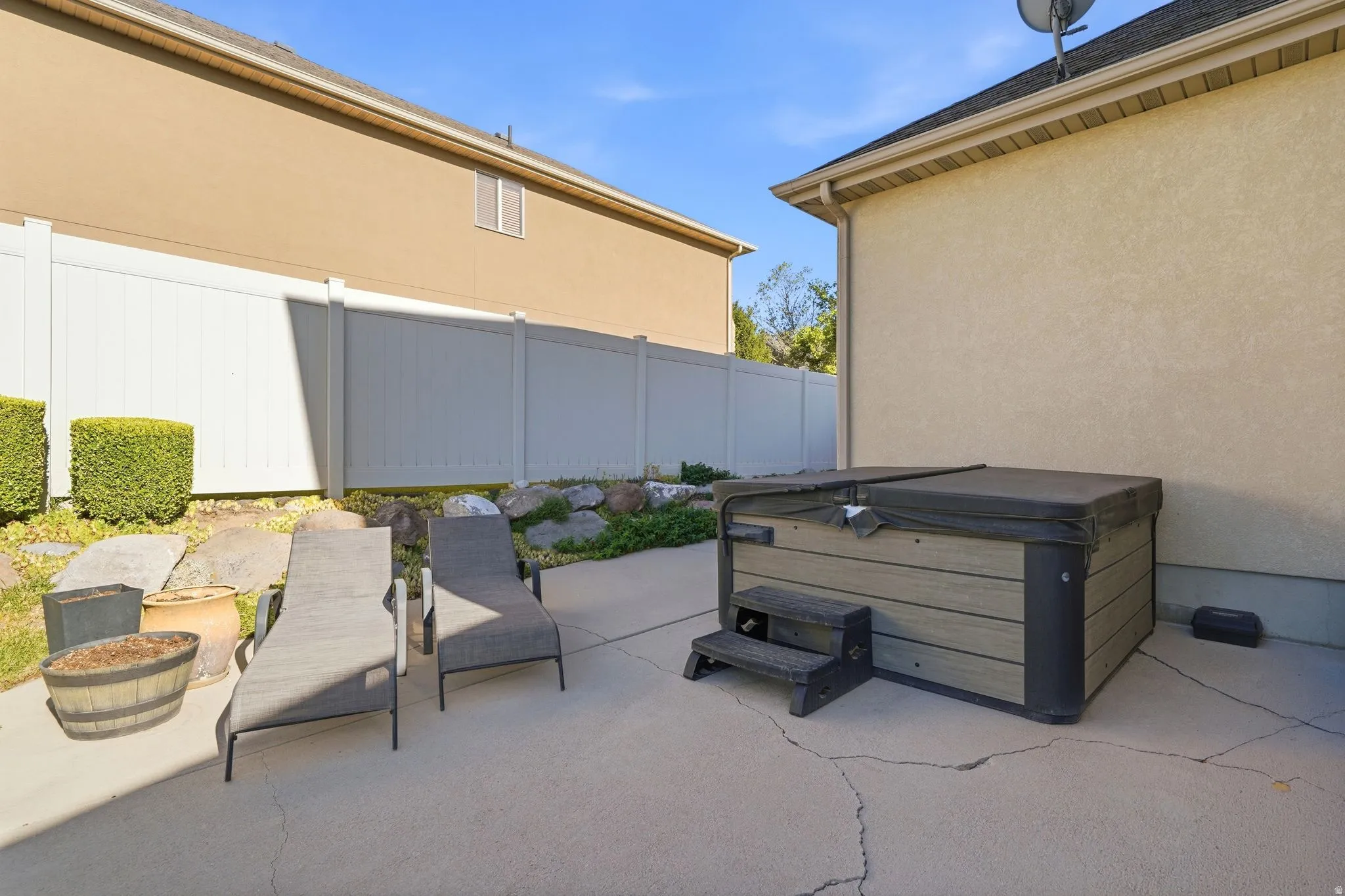 Side yard featuring included hot tub