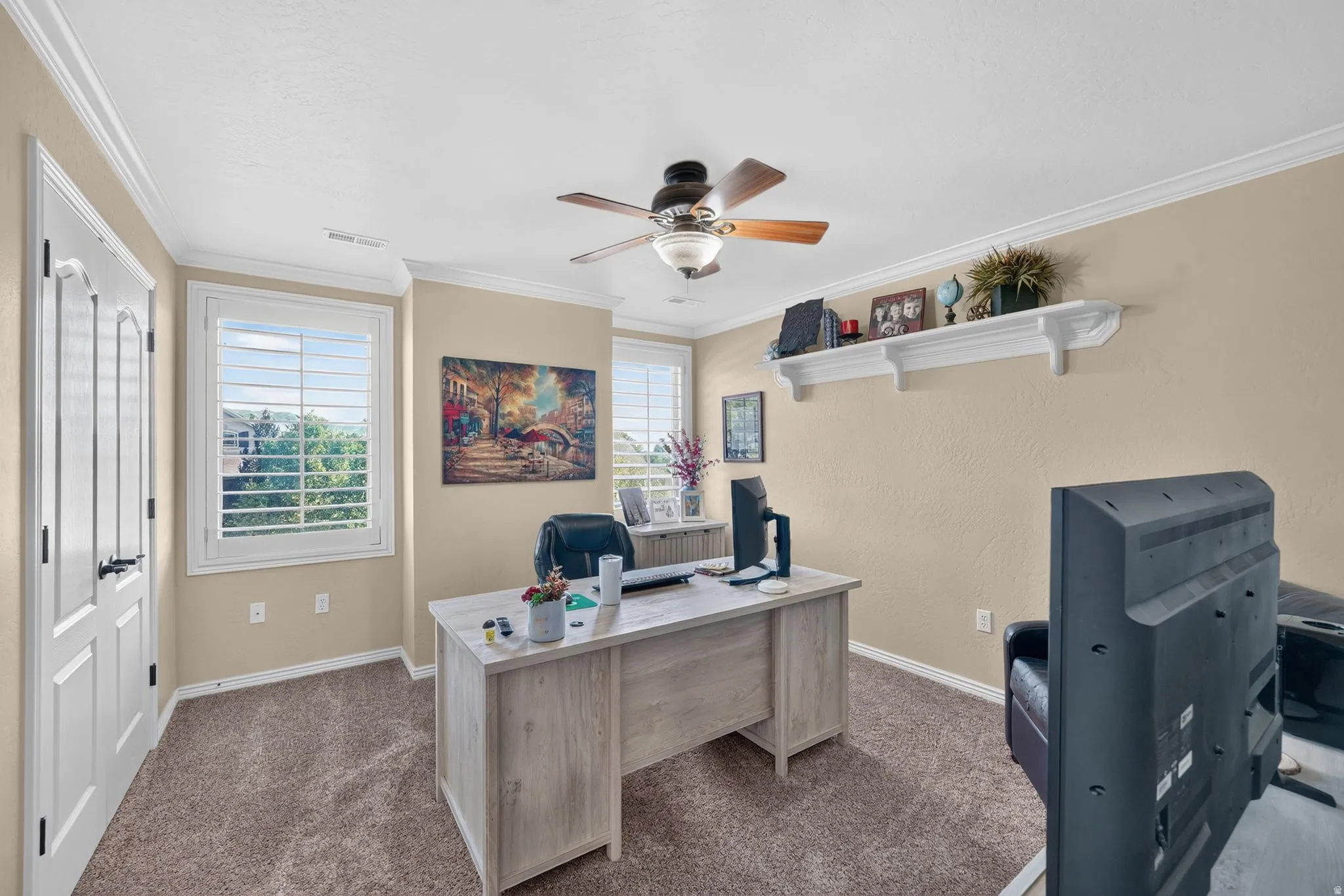 Second spare bedroom featuring neutral-toned walls, textured carpeting, and white crown molding