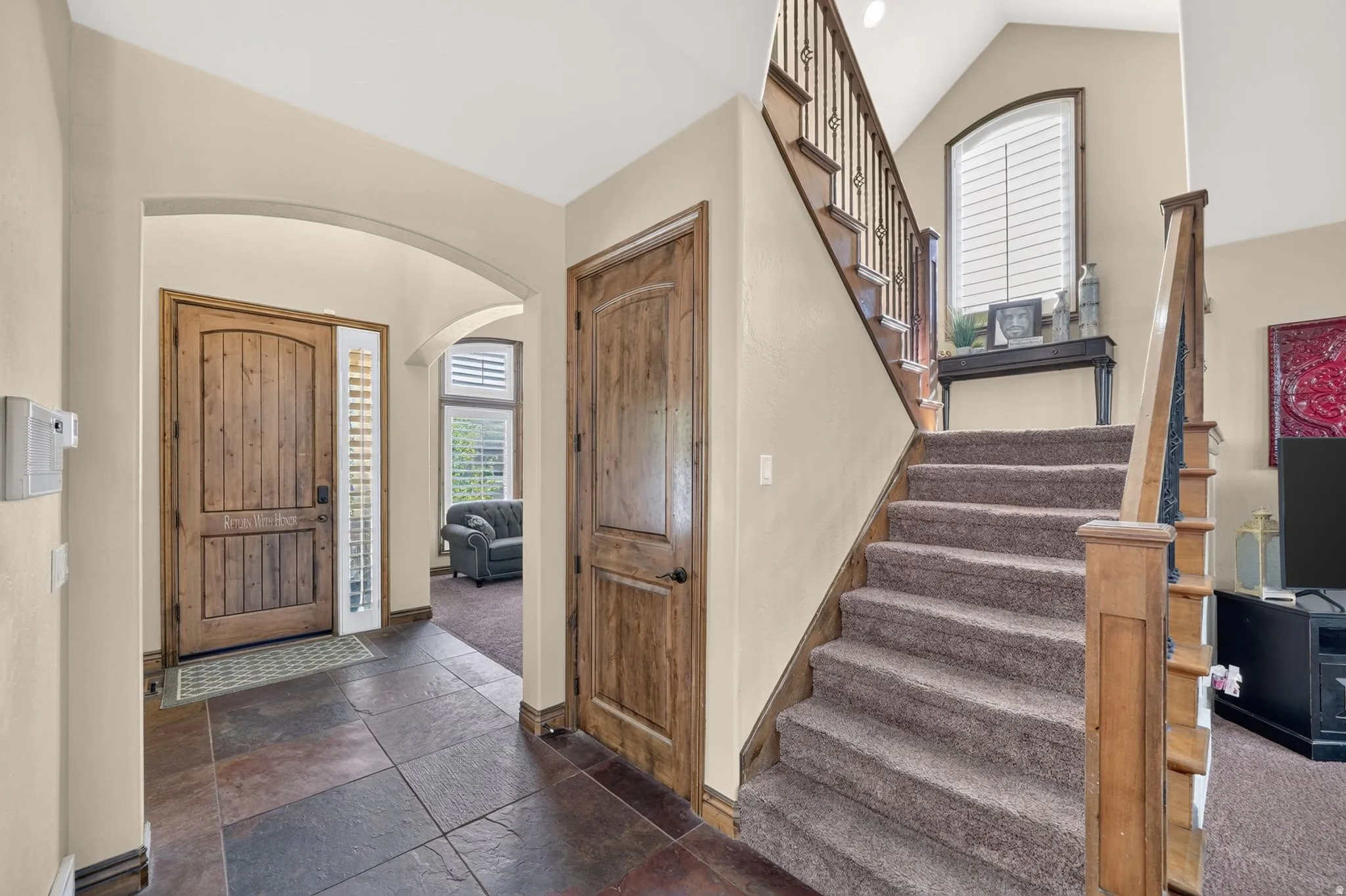 Entrance foyer showcasing wood designed staircase