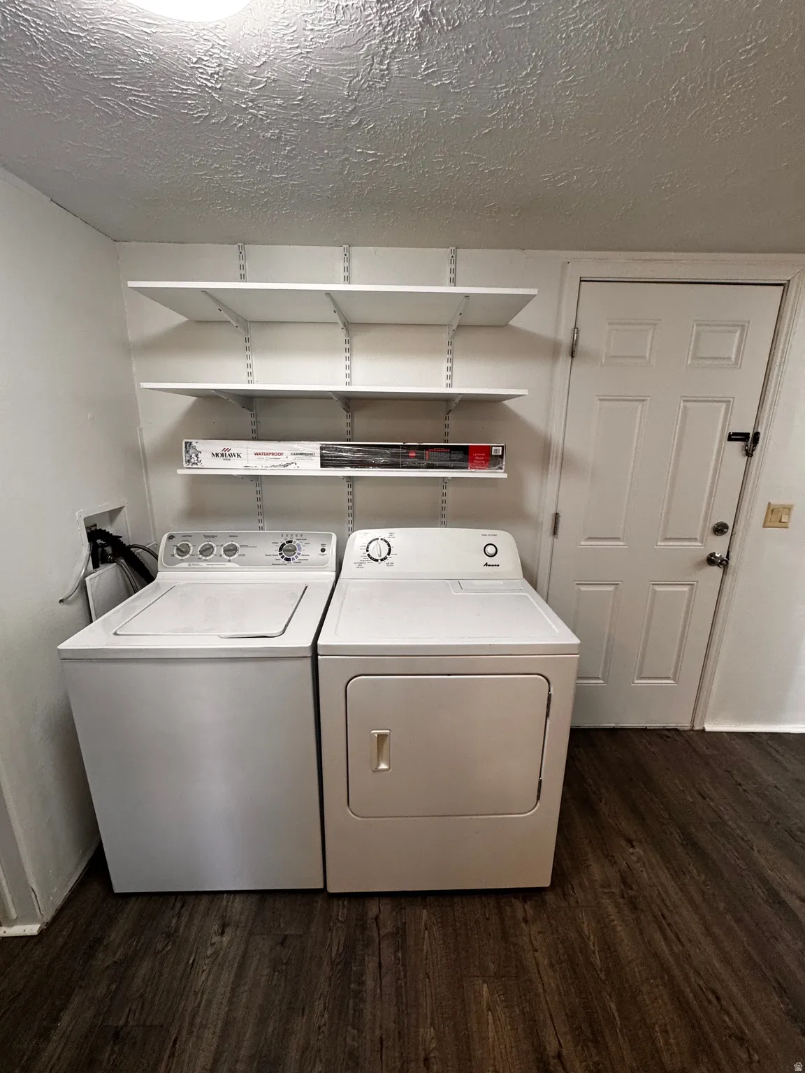 Dedicated laundry area featuring a white washing machine and dryer