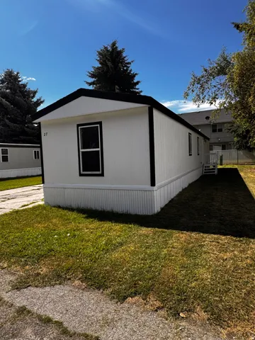 White exterior with black trim and a dark-pitched roof