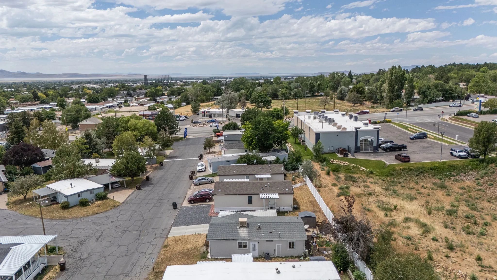 Aerial perspective showcasing residential properties and a commercial building