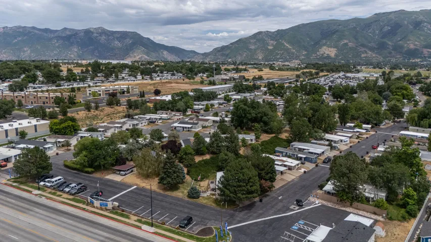 Expansive community featuring mature trees, paved streets, and mountain scenery