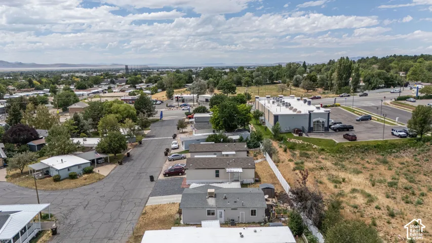 Aerial perspective showcasing residential properties and a commercial building