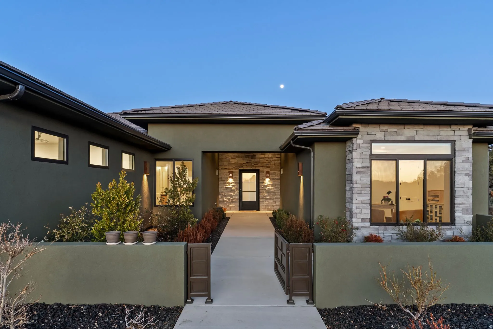 Contemporary exterior with stucco and stone veneer accents