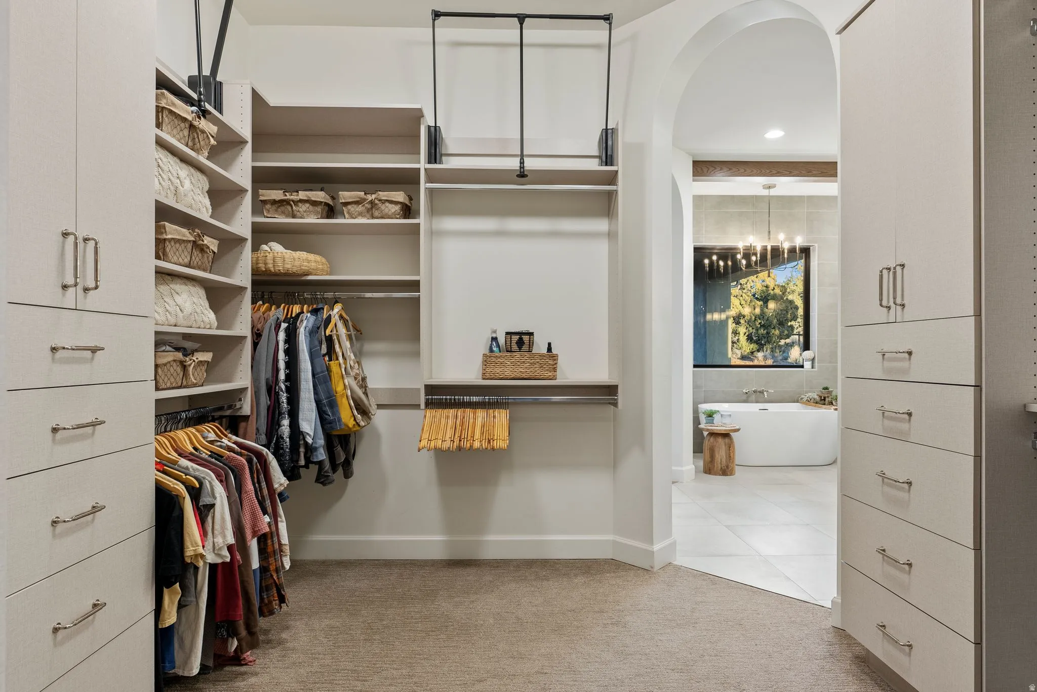 Custom closet system featuring built-in cabinetry, shelving, and hanging rods