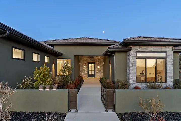 Contemporary exterior with stucco and stone veneer accents