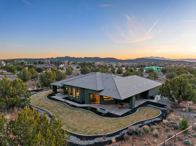 Modern single-story residence with a gray tile roof and a spacious rear patio