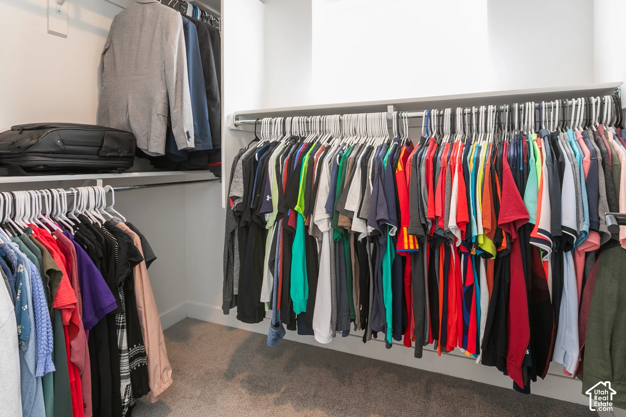 Integrated closet system featuring white shelving and hanging rods