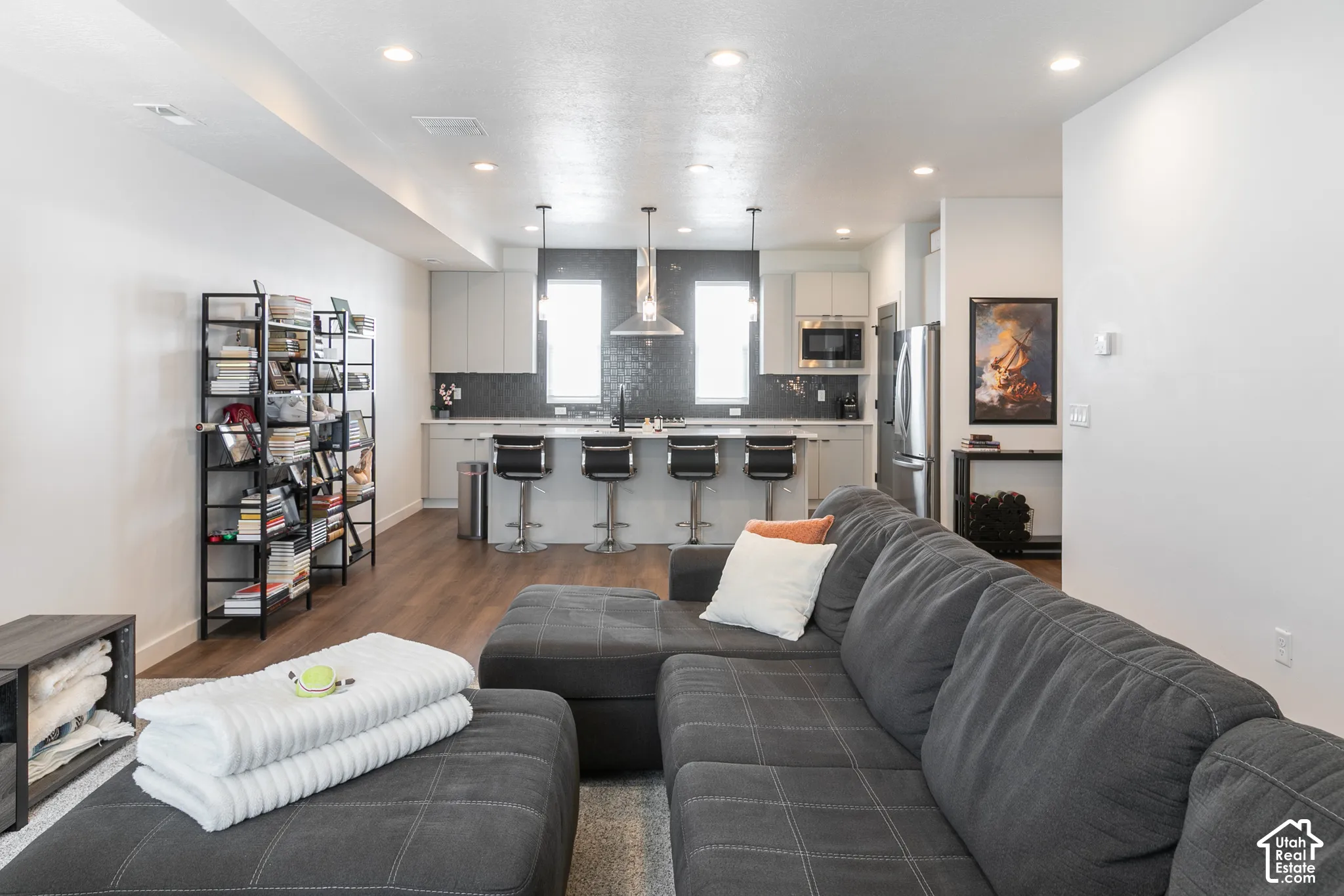 Open-concept living area featuring wood-finish flooring