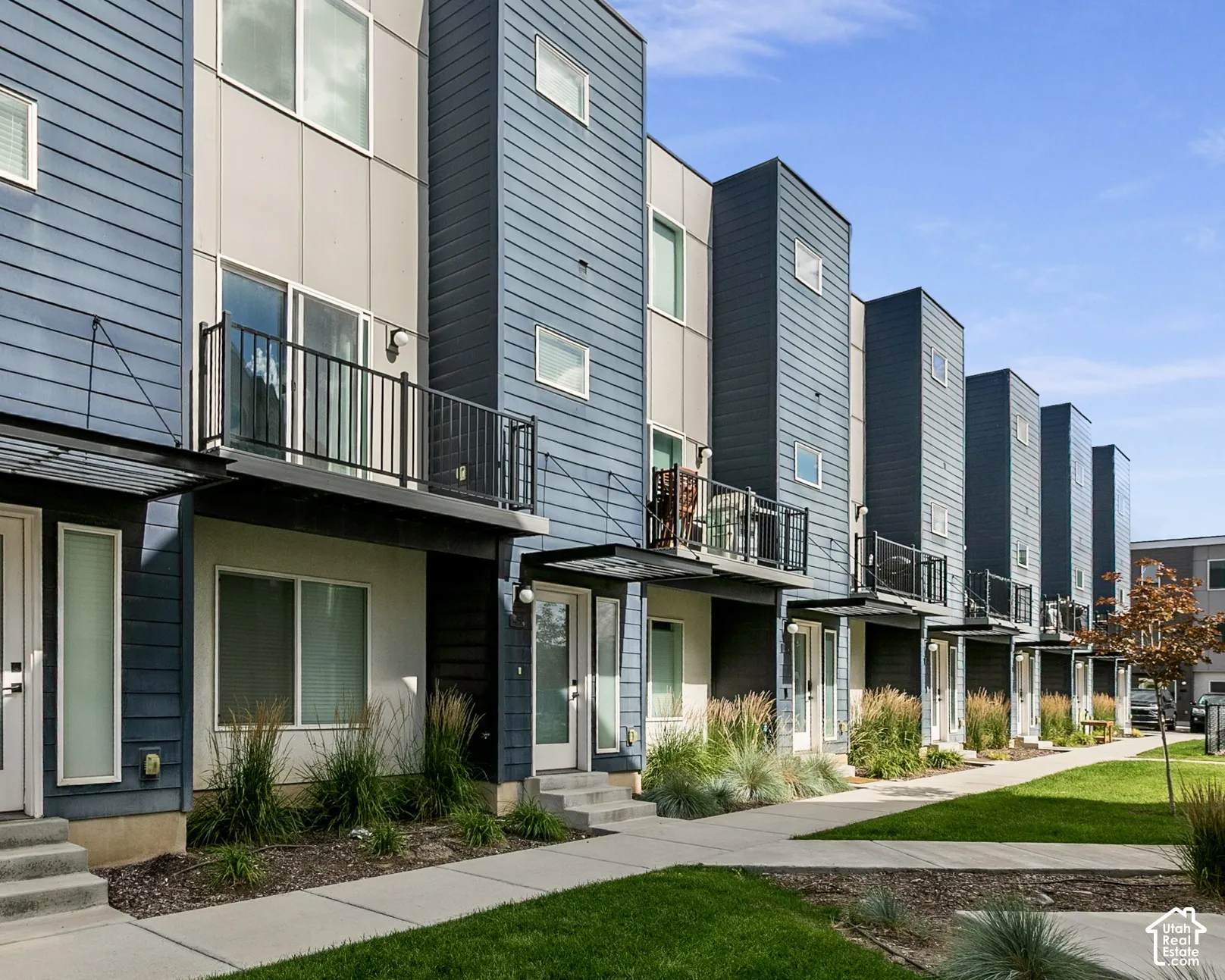 Contemporary multi-story townhome with a blue and gray facade