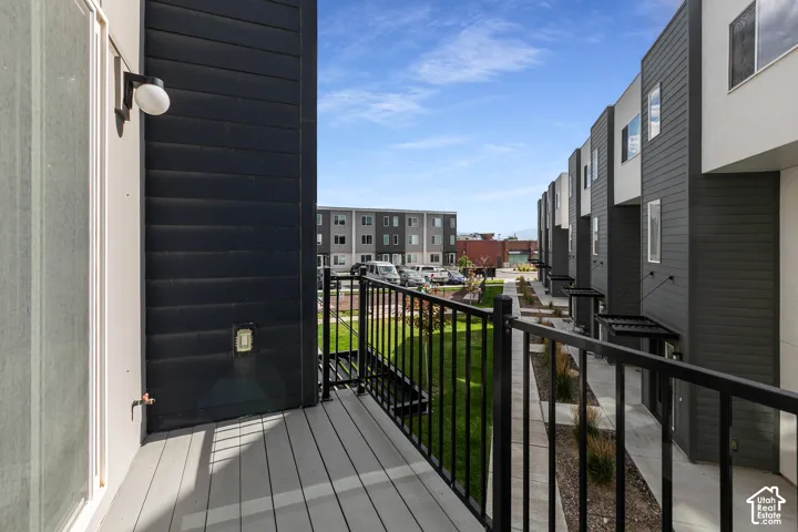 Private balcony with composite decking and black metal railing