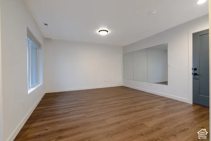Bonus room could be used as office, family room, exercise room, or whatever you like. Wood-finish flooring, wall-mounted mirror and light colored walls