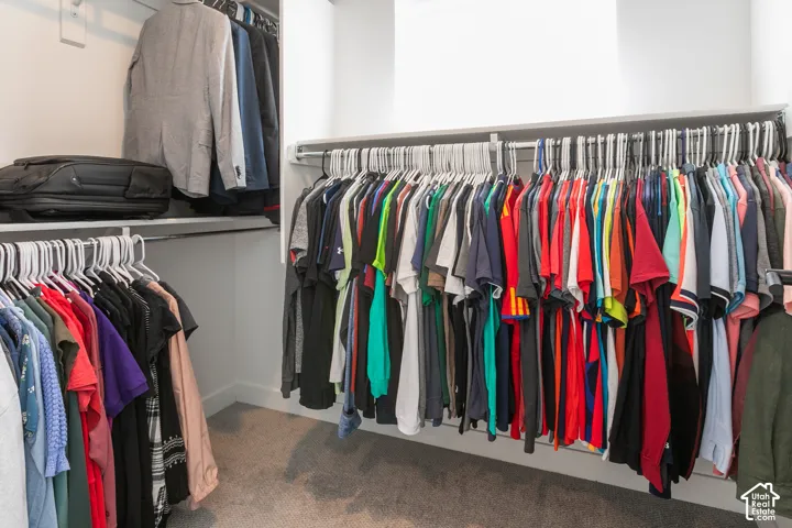 Integrated closet system featuring white shelving and hanging rods