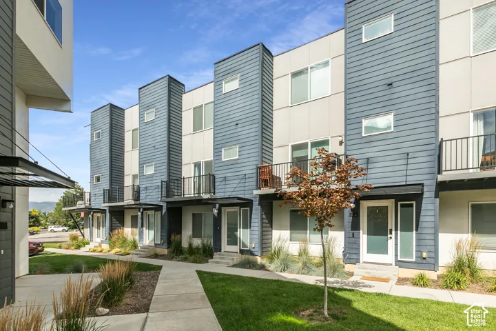Modern townhome exterior featuring gray/blue horizontal lap siding, panelized fa