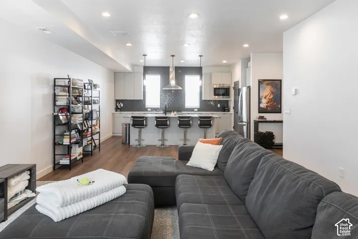 Open-concept living area featuring wood-finish flooring