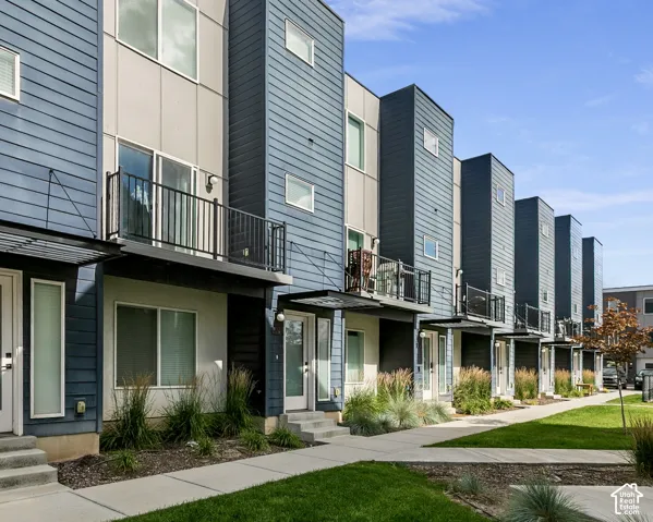 Contemporary multi-story townhome with a blue and gray facade