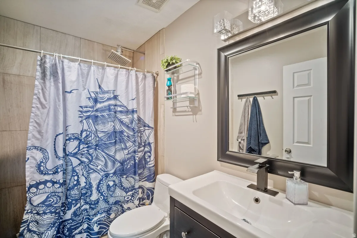 Bathroom vanity with a dark wood-finish base, white countertop, and integrated sink